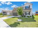 Beautiful two-story home with a manicured lawn, landscaped garden, and a brick and siding exterior at 1454 Silver Pine Ln, Sheridan, IN 46069