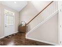 Inviting entryway with hardwood floors, a staircase, and a charming accent table at 15421 Bowie Dr, Westfield, IN 46074