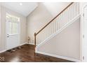 Hardwood foyer featuring a white front door and staircase with wood railing at 15421 Bowie Dr, Westfield, IN 46074