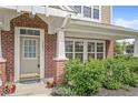 Inviting front porch with brick pillars, a neutral front door, and well-maintained landscaping at 15421 Bowie Dr, Westfield, IN 46074