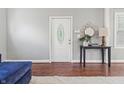 Bright entryway featuring hardwood floors, a white front door with glass insert, and a stylish console table at 1720 Woodlawn Ave, Indianapolis, IN 46203