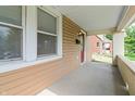 Covered front porch, showcasing the home's entrance, white brickwork, and natural light at 1720 Woodlawn Ave, Indianapolis, IN 46203