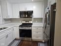 Bright kitchen showcasing stainless steel appliances, white cabinetry, and quartz countertops at 1733 E 47Th St, Anderson, IN 46013
