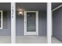 Close-up of the front door and porch of the gray home, showing the house number at 1826 Shorter Dr, Indianapolis, IN 46214