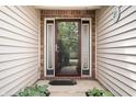 Inviting front entrance with a decorative glass door and sidelights, framed by brick and lush greenery at 18913 Course View Rd, Noblesville, IN 46060
