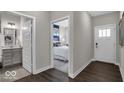 Bright hallway with a view into bedroom and bathroom, featuring modern neutral paint at 19390 Mcbee Ave, Westfield, IN 46074