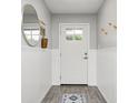Bright entryway featuring decorative wainscoting, wood-look floors and stylish accents at 203 Leerkamp Dr, Franklin, IN 46131