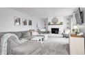 Cozy living room featuring a brick fireplace, plush seating, and neutral tones at 203 Leerkamp Dr, Franklin, IN 46131