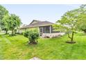 Spacious backyard with mature trees and a screened-in porch, ideal for outdoor enjoyment at 2044 Flamingo Way, Franklin, IN 46131