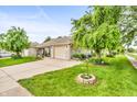 Well-maintained home featuring a brick facade, attached garage, and a lush green yard at 2044 Flamingo Way, Franklin, IN 46131