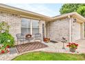 Cozy porch with decorative chairs, flowers, and a 'Welcome' sign, creating a warm entry at 2044 Flamingo Way, Franklin, IN 46131
