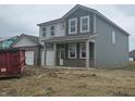 Charming home featuring gray siding, brick accents, and a welcoming front porch at 2287 Oakmont Dr, Plainfield, IN 46168