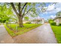 Inviting single-story home with a long driveway and fenced yard at 2726 Apache Dr, Anderson, IN 46012