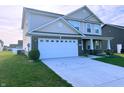 Lovely two-story house featuring a two-car garage, a well-kept lawn and a brick-accented facade at 276 Rocky Rd, Greenfield, IN 46140