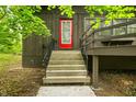 Inviting home entrance with charming steps, a quaint porch, and a vibrant red front door at 2781 E Vandalia Rd, Flat Rock, IN 47234