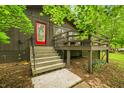 Inviting home exterior with charming steps, a quaint porch, and a vibrant red front door at 2781 E Vandalia Rd, Flat Rock, IN 47234