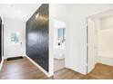 View of front door, foyer, wood-look flooring and view into bedroom and bathroom at 2948 Woods Edge Dr, Greenwood, IN 46143