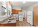 The kitchen features ample natural light, a standard appliance package and warm cabinets at 3134 N College Ave, Indianapolis, IN 46205