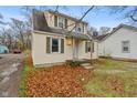 Charming two-story home with siding, green shutters, and fall foliage at 3305 N Arlington Ave, Indianapolis, IN 46218