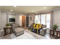 Cozy living room provides natural light, modern decor, and a large mirror creating an open, airy atmosphere at 3514 Summerfield Dr, Indianapolis, IN 46214