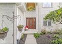 Elegant front entrance featuring a beautiful wooden door, decorative hanging planters, and inviting details at 3655 Copperleaf Blvd, Greenwood, IN 46143