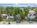 An aerial view showcasing the neighborhood and the home's well-treed surroundings at 401 Harlan St, Indianapolis, IN 46201