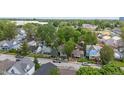 An aerial view showcasing the neighborhood and the home's well-treed surroundings at 401 Harlan St, Indianapolis, IN 46201