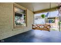 Quaint front porch featuring a wooden swing, decorative window, and serene outdoor space at 517 Bernard Ave, Indianapolis, IN 46208
