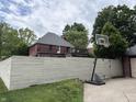 Backyard view featuring a tall privacy fence and a basketball hoop for recreational enjoyment at 5401 N New Jersey St, Indianapolis, IN 46220