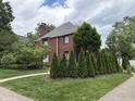 Beautifully landscaped brick home featuring a lush green lawn and charming curb appeal at 5401 N New Jersey St, Indianapolis, IN 46220