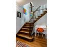 Elegant wooden staircase with iron railings, complemented by a stylish desk and decor at 5401 N New Jersey St, Indianapolis, IN 46220