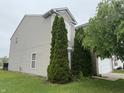 Home exterior with manicured lawn, lush greenery, and vinyl siding at 5502 Floating Leaf Dr, Indianapolis, IN 46237