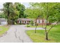 Beautiful property featuring a detached garage and a basketball hoop out front at 6030 Riverview Dr, Indianapolis, IN 46208
