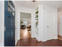 Inviting foyer with tile flooring, a blue front door, and views into the living room at 6030 Riverview Dr, Indianapolis, IN 46208