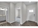 Bright entryway with white trim, wood floors, and a view into the bedroom and bathroom at 611 Bridgeman Rd, Avon, IN 46123