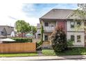 View of the home's exterior showing fenced yard and landscaping at 635 E 10Th St, Indianapolis, IN 46202