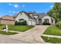 Beautiful two-story white brick home with an attached two-car garage, lovely landscaping, and a concrete driveway at 6610 Royal Oakland Dr, Indianapolis, IN 46236