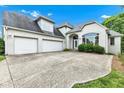 A spacious white brick home boasts a two-car garage and plenty of driveway space at 6610 Royal Oakland Dr, Indianapolis, IN 46236