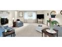 Inviting living room with plush carpeting, ample natural light from the windows, and comfortable seating arrangement at 8641 Cholla Rd, Indianapolis, IN 46240