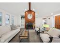 Bright living room with fireplace, wood beam, white couch, and large windows at 8802 W 86Th St, Indianapolis, IN 46278