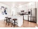 Modern kitchen featuring white cabinetry, stainless steel appliances, and a center island with seating at 918 S State Ave, Indianapolis, IN 46203