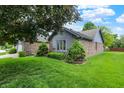 Well-manicured lawn with decorative shrubs enhance this home's curb appeal at 926 Brookside Ln, Plainfield, IN 46168