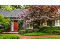 Charming front entry with a red door, brick path, and manicured landscaping at 9550 Copley Dr, Indianapolis, IN 46260
