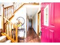 Inviting entryway with hardwood floors, staircase, and a view of the hallway and front door at 1010 Lakewood N Dr, Brownsburg, IN 46112