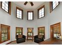 Cozy sitting area with multiple windows offering abundant natural light and comfortable leather chairs at 1010 Lakewood N Dr, Brownsburg, IN 46112