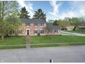 Inviting brick home with a well-manicured lawn, mature trees and a classic brick walkway at 10245 Briar Creek Ln, Carmel, IN 46033