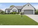 Traditional style white home with grey trim, lovely landscaping and attached two car garage at 10510 Inverness Ct, Fishers, IN 46037
