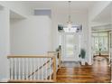 Elegant foyer with gleaming hardwood floors, a staircase and a stylish chandelier at 10510 Inverness Ct, Fishers, IN 46037