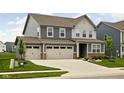 Charming two-story home with a well-maintained lawn, inviting curb appeal, and an attached two car garage at 11588 Brooks Farm Blvd, Noblesville, IN 46060