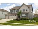 Charming two-story home with a well-maintained lawn, inviting curb appeal, and an attached two car garage at 11588 Brooks Farm Blvd, Noblesville, IN 46060